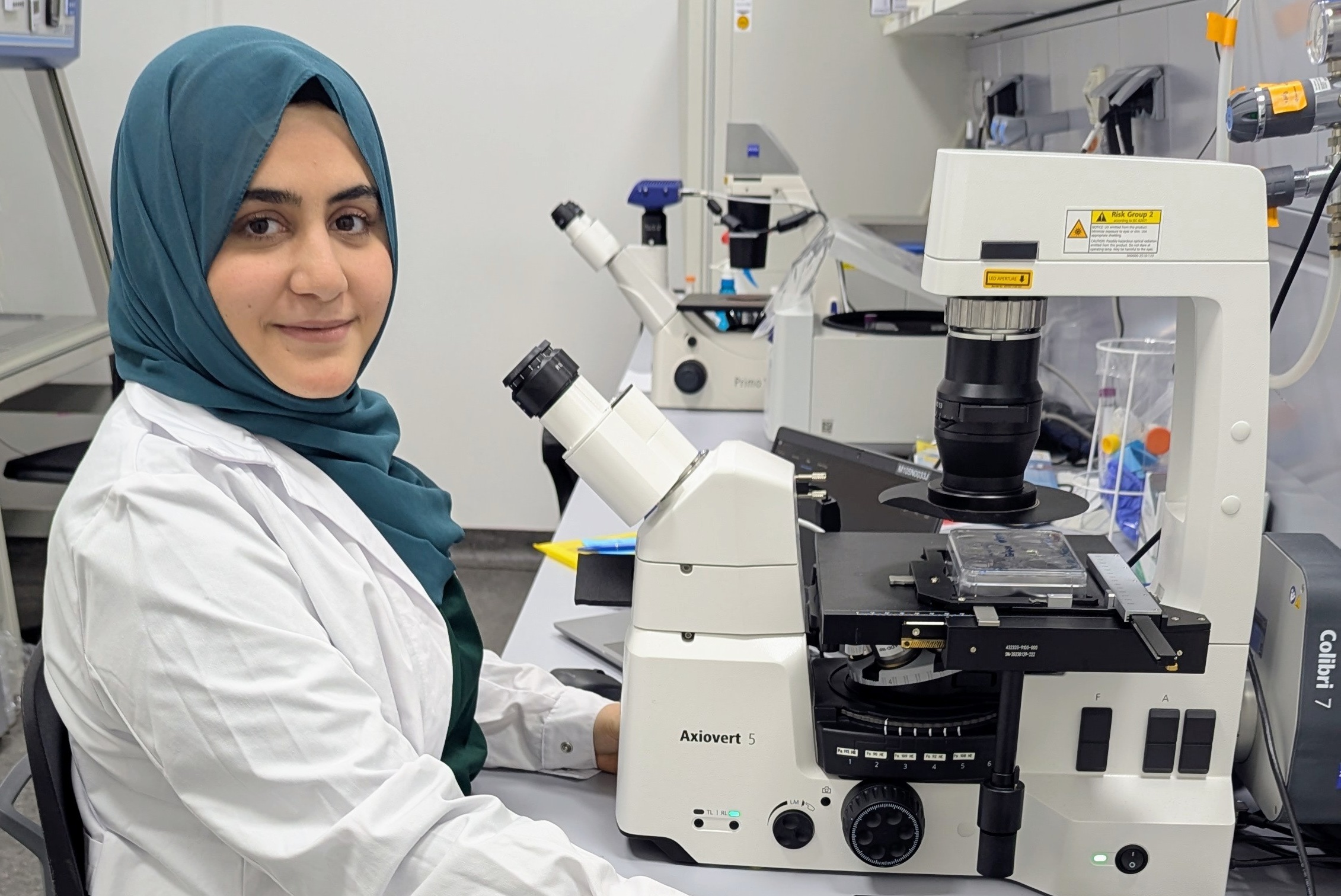 Photo of Hira Javed at the microscope